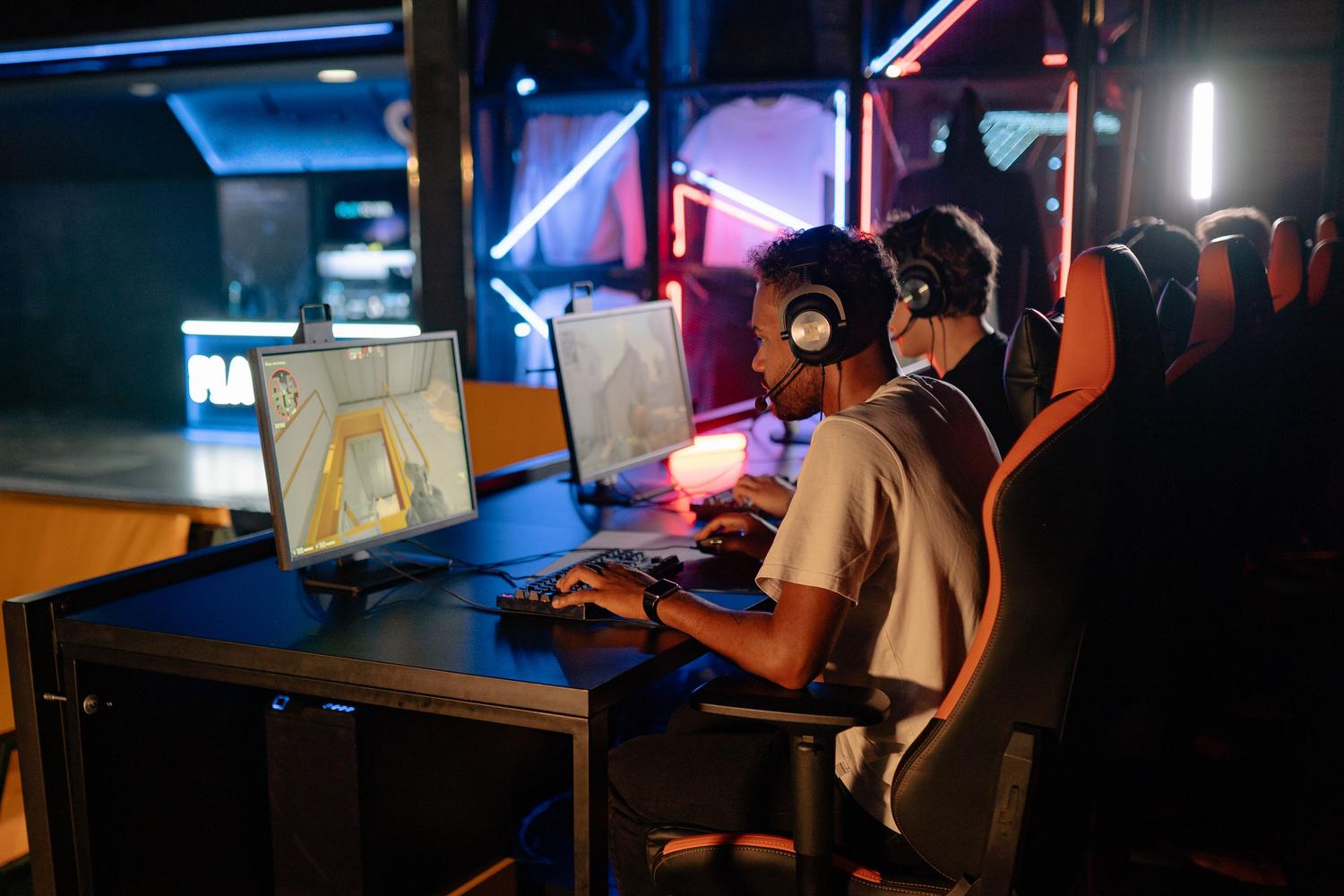 Group of gamers with headsets in a neon-lit gaming center, representing a Discord gaming community.