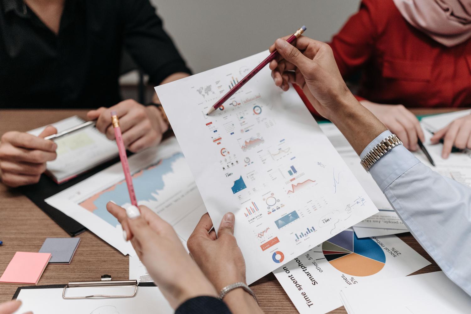 Professionals analyzing business reports and metrics, representing Business Impact Analysis (BIA).