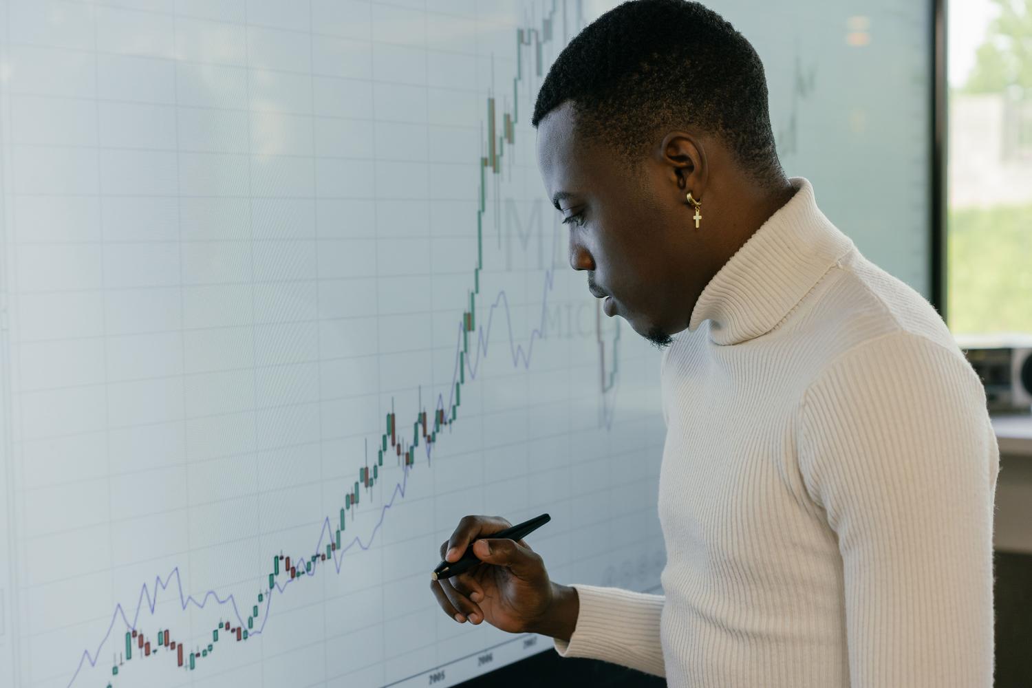 Estratega financiero analizando tendencias de crecimiento económico en una pantalla digital profesional.
