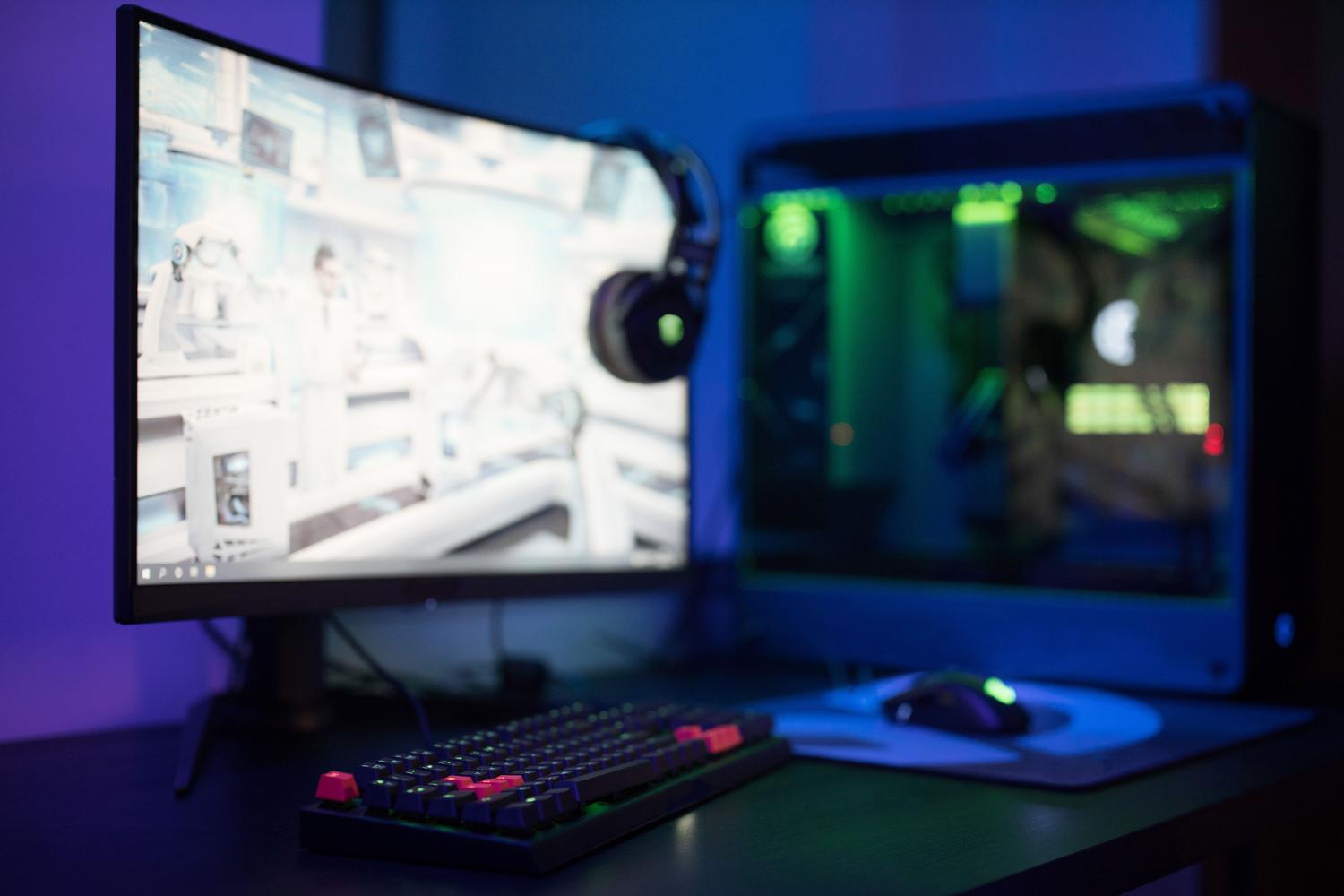 Estación de juego avanzada con monitor curvo y periféricos iluminados, representando la experiencia de gaming moderna.