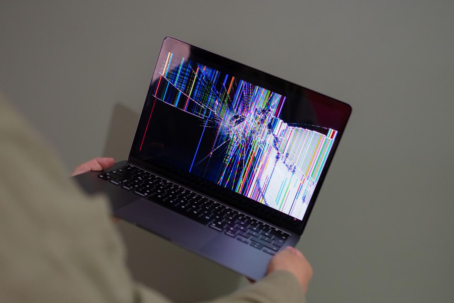 Laptop screen broken with a colorful glitch effect, symbolizing chaos and data loss due to technical errors. Laptop screen broken with a colorful glitch effect, symbolizing chaos and data loss due to technical errors.