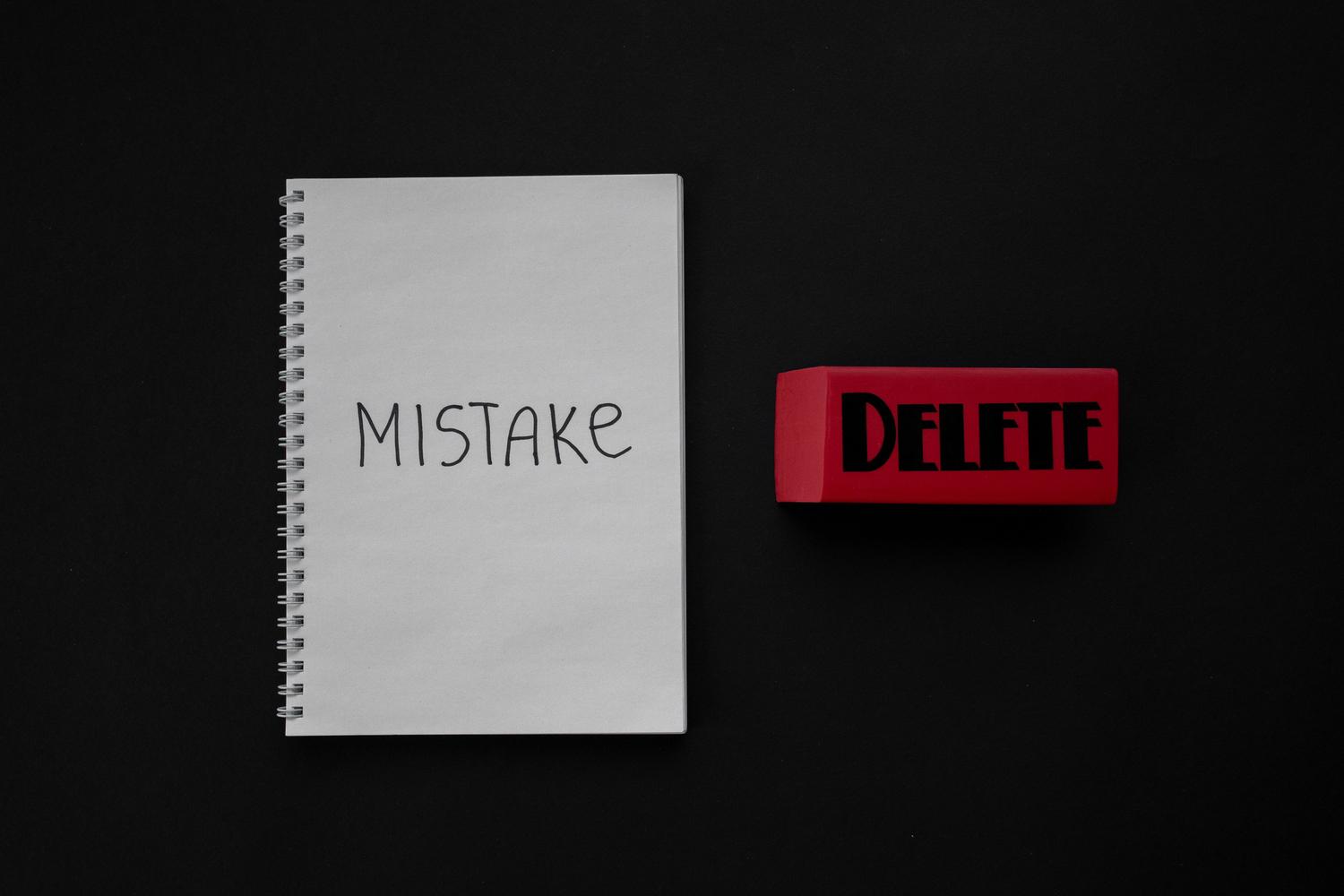 Notebook with the word 'Mistake' next to a red eraser, illustrating accidental deletions of files in the cloud.