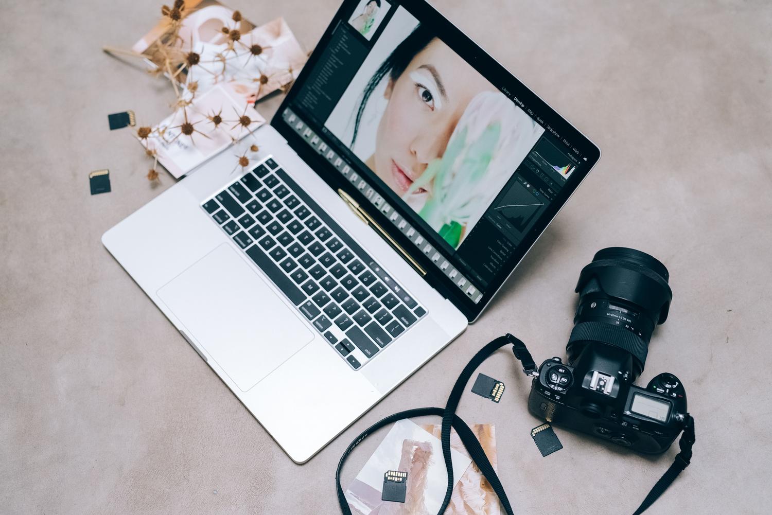 Workspace with laptop, camera and memory cards for equipment maintenance
