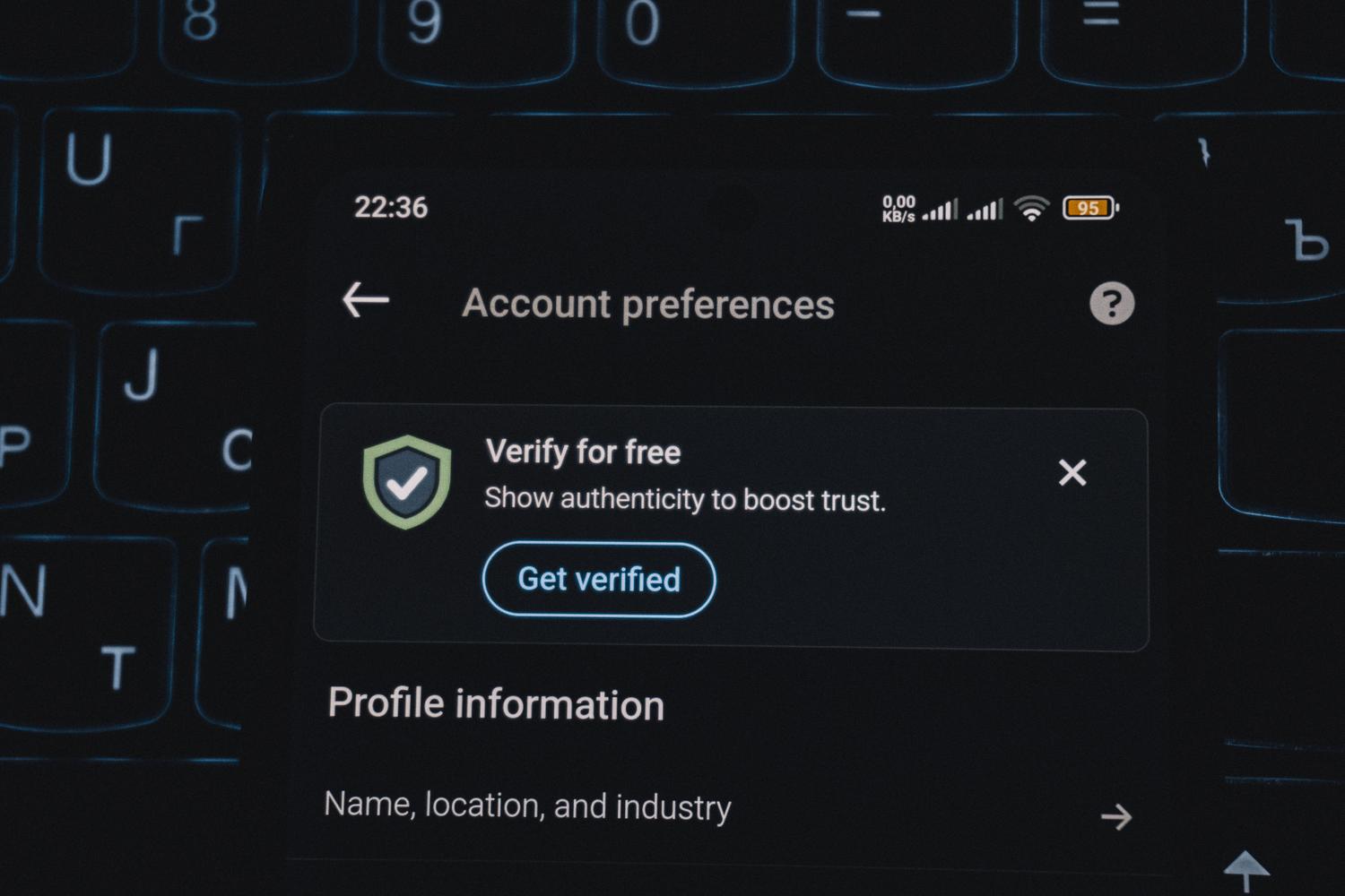 Primer plano de la pantalla de un smartphone mostrando una alerta de verificación de cuenta para autenticación multifactor (MFA).