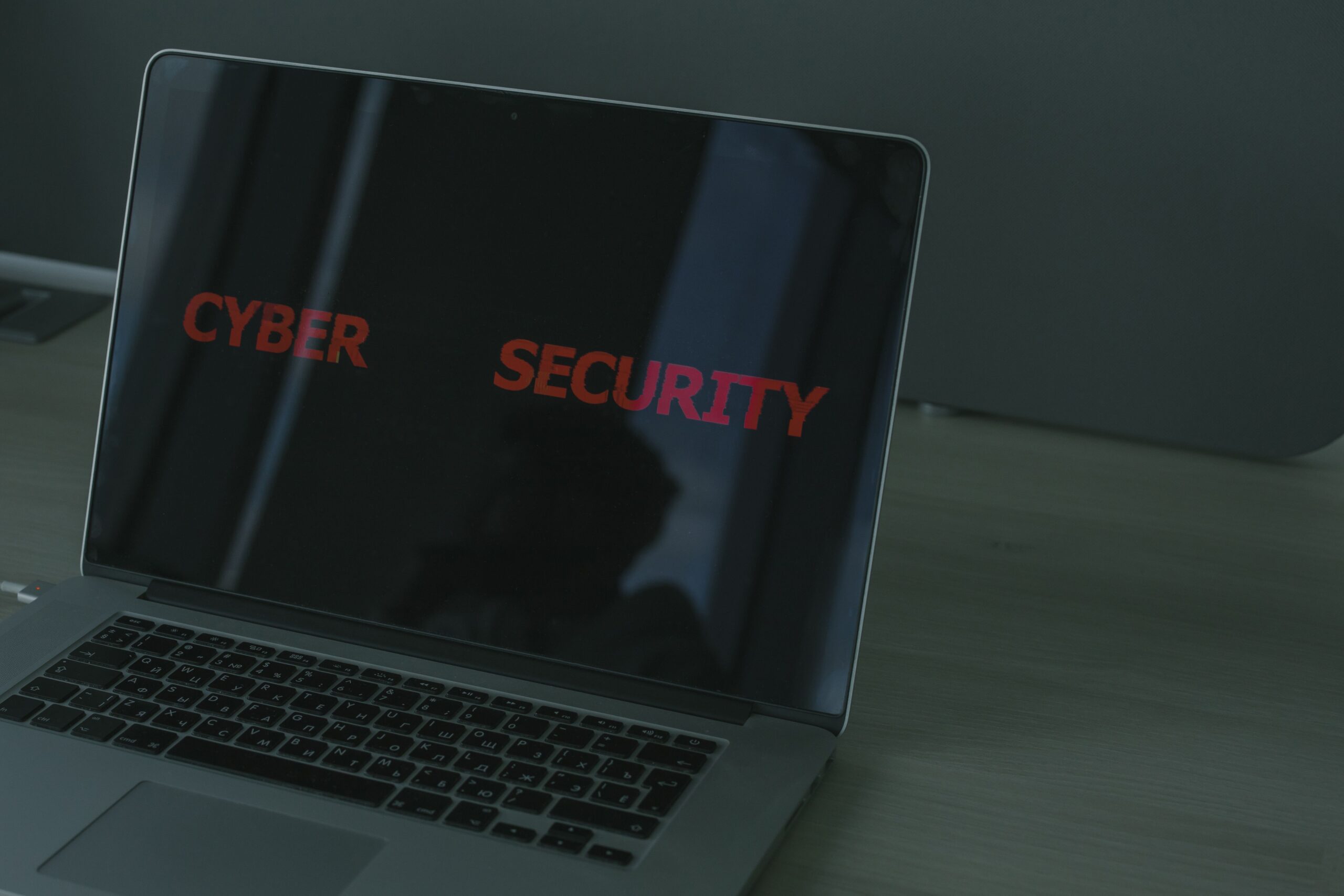 Laptop con el texto 'CYBER SECURITY' en pantalla, representando la seguridad digital y la protección en Windows 11.