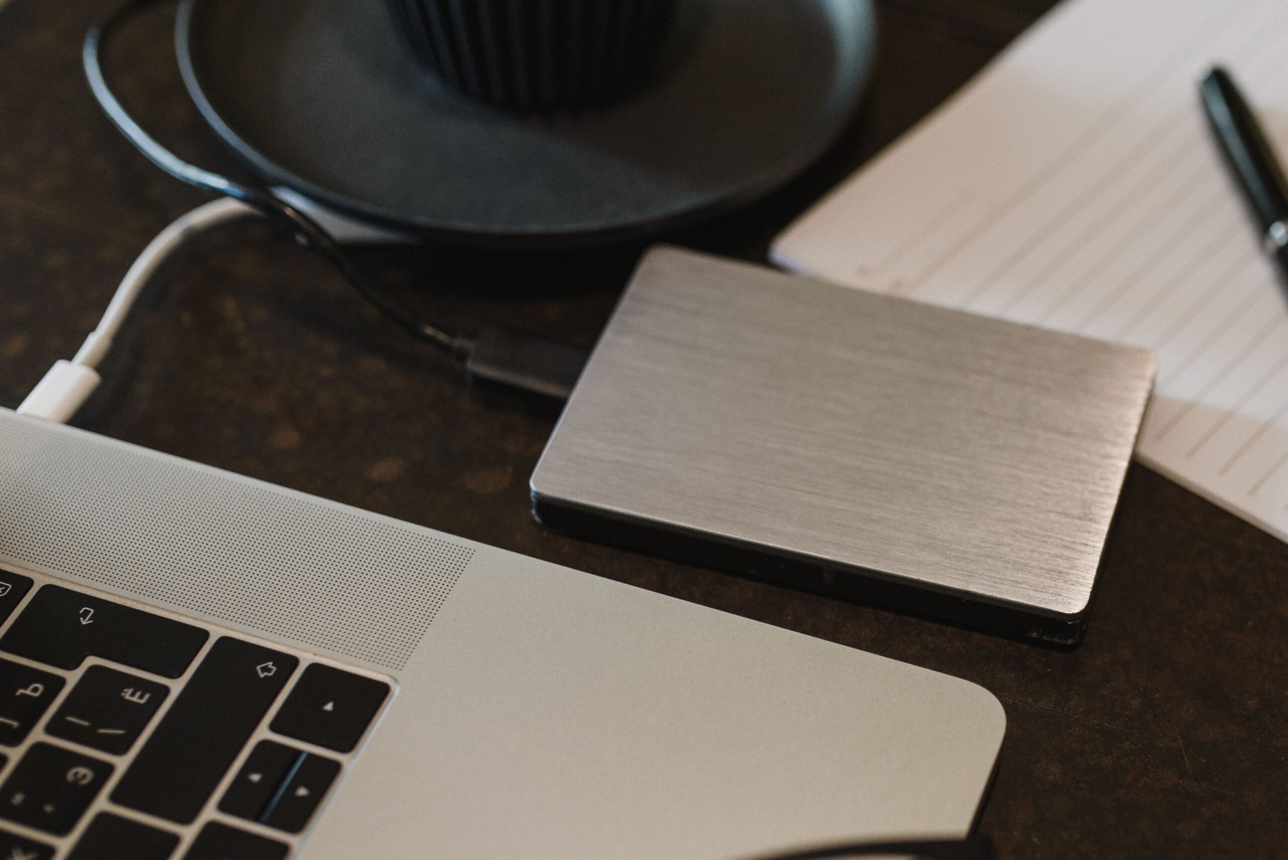 Disco duro externo conectado a un portátil mediante un cable USB, simbolizando la importancia de realizar copias de seguridad preventivas.