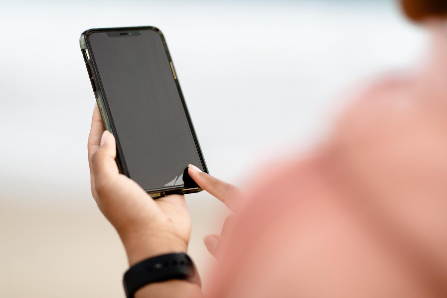 Close-up of a person adjusting settings on a modern smartphone, representing the optimization of Android animation scales.