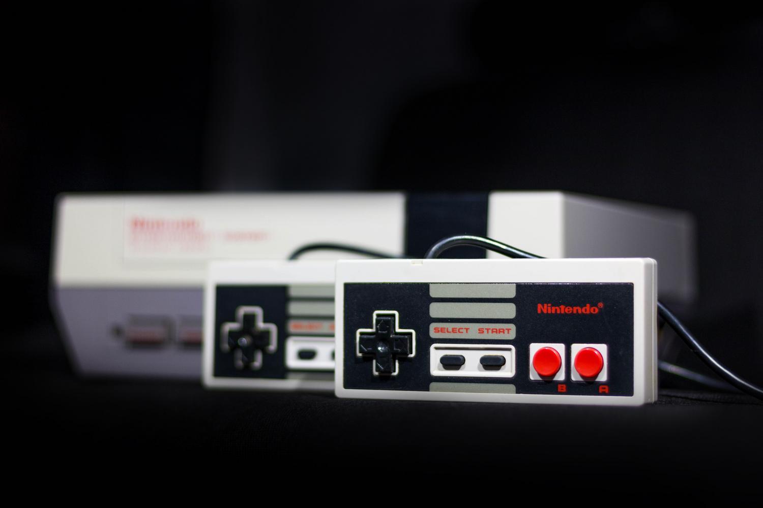 Consola Nintendo NES clásica y sus mandos, icono representativo de la era de los videojuegos antiguos.