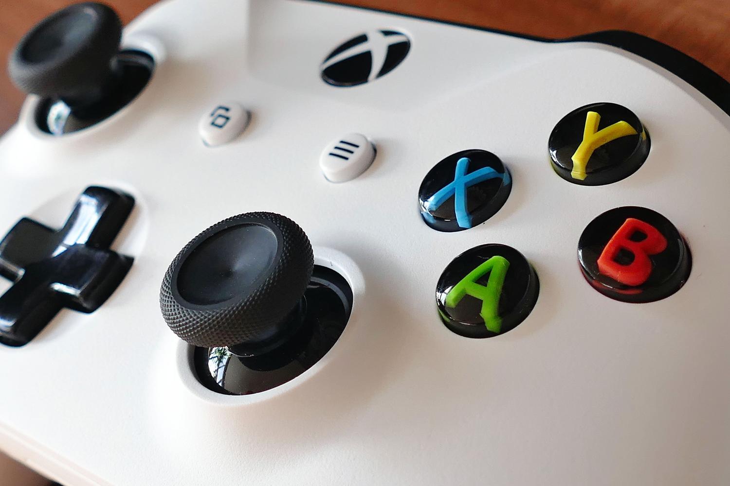 Primer plano de los botones y joysticks de un mando de juego blanco, ideal para ilustrar el mantenimiento de periféricos