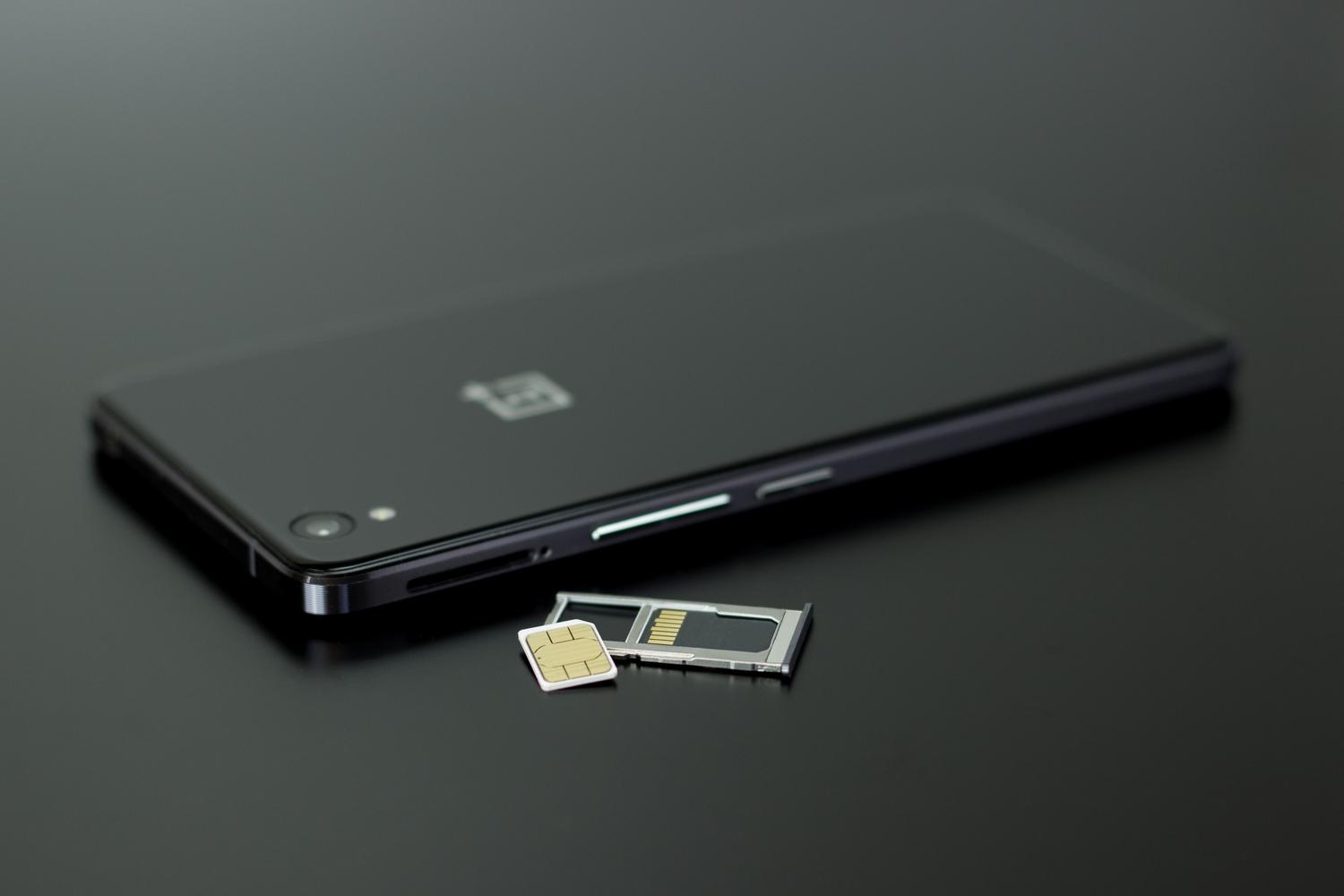 Primer plano de un smartphone con tarjeta SIM y tarjeta de memoria, útil como imagen general de los componentes involucrados.