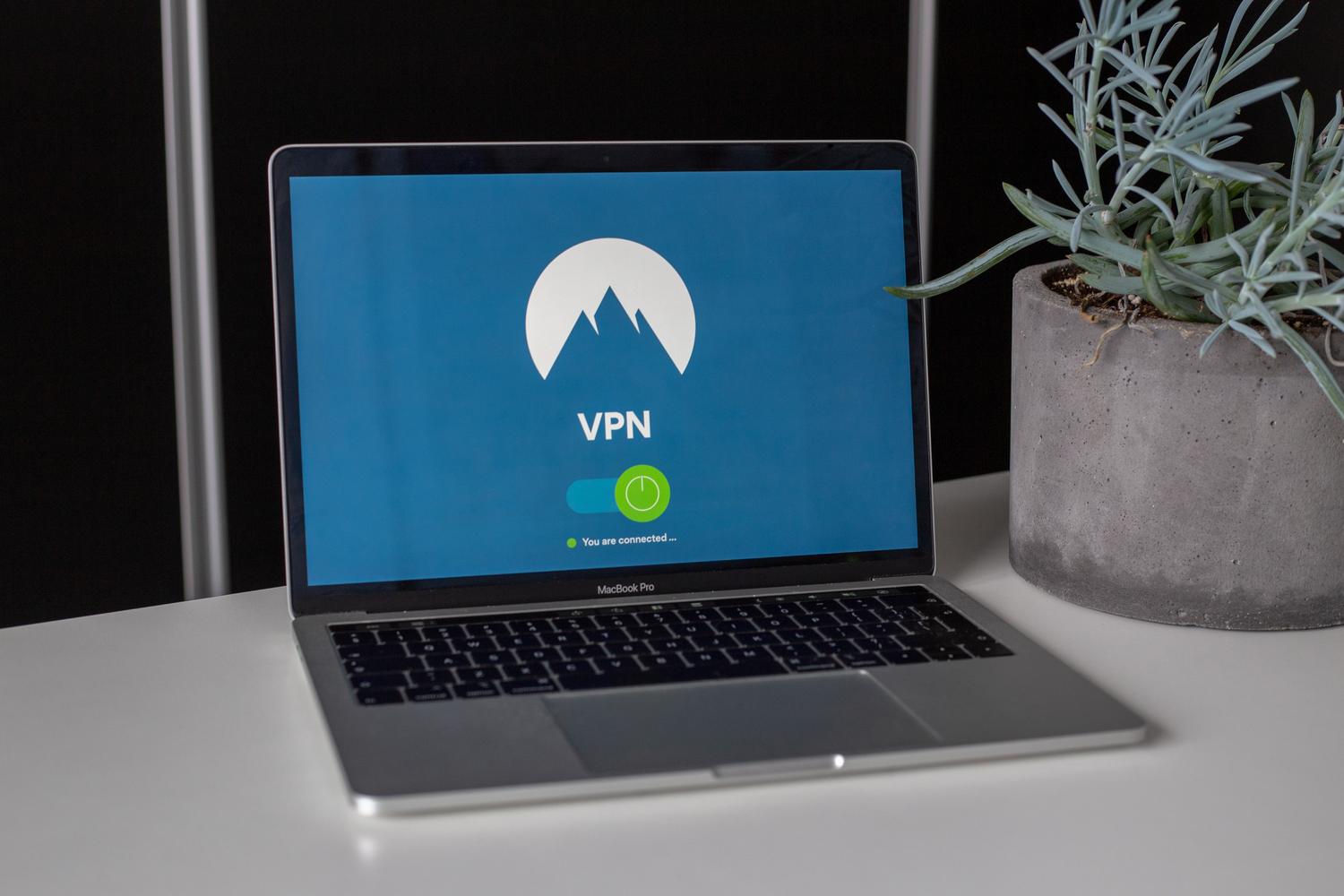Espacio de trabajo moderno con un portátil mostrando una conexión VPN, enfatizando la privacidad y seguridad digital.