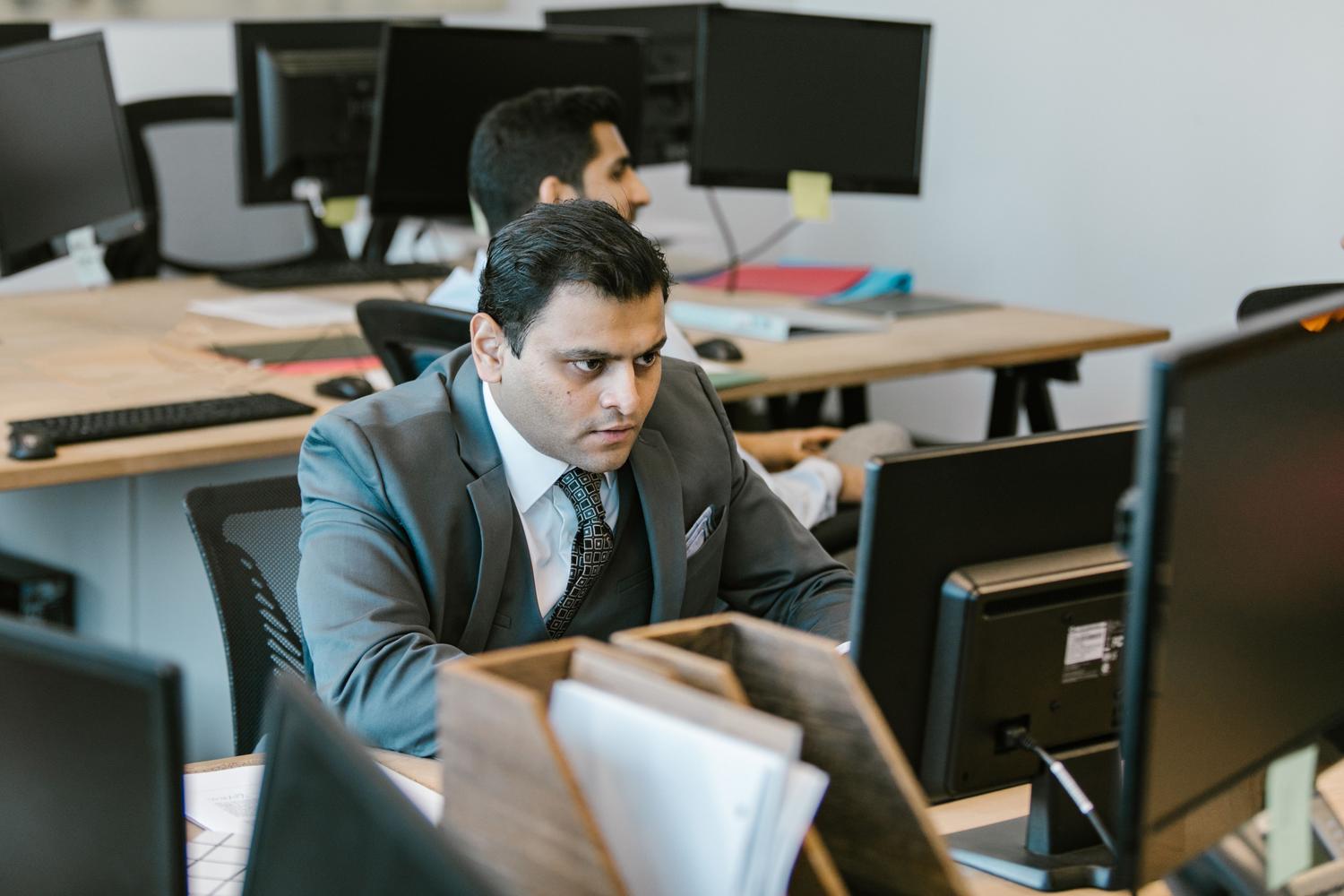 Profesional trabajando en un ordenador en una oficina moderna optimizando su productividad