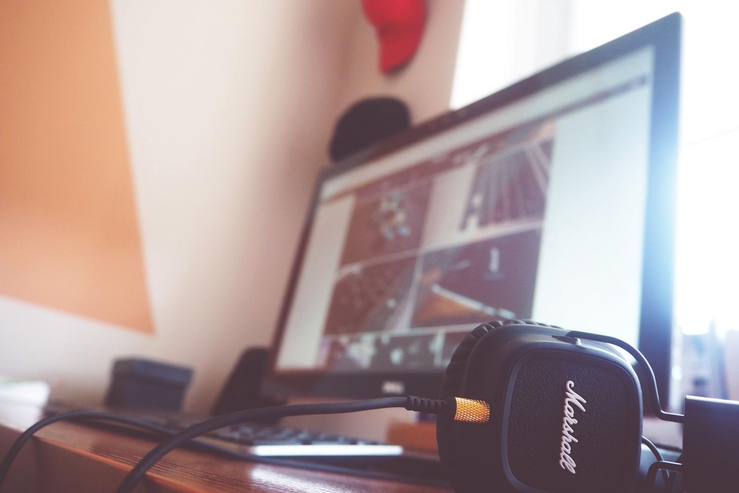 Primer plano de unos auriculares conectados a un ordenador, ideal para ilustrar la comprobación de cables y conexiones físicas.