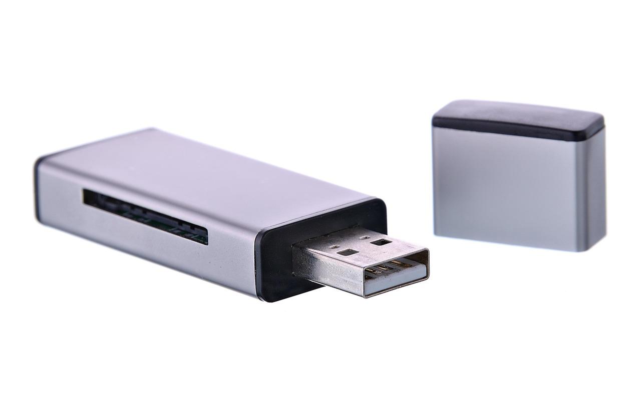 Primer plano de una memoria USB blanca sobre fondo neutro, representando el dispositivo de almacenamiento externo.