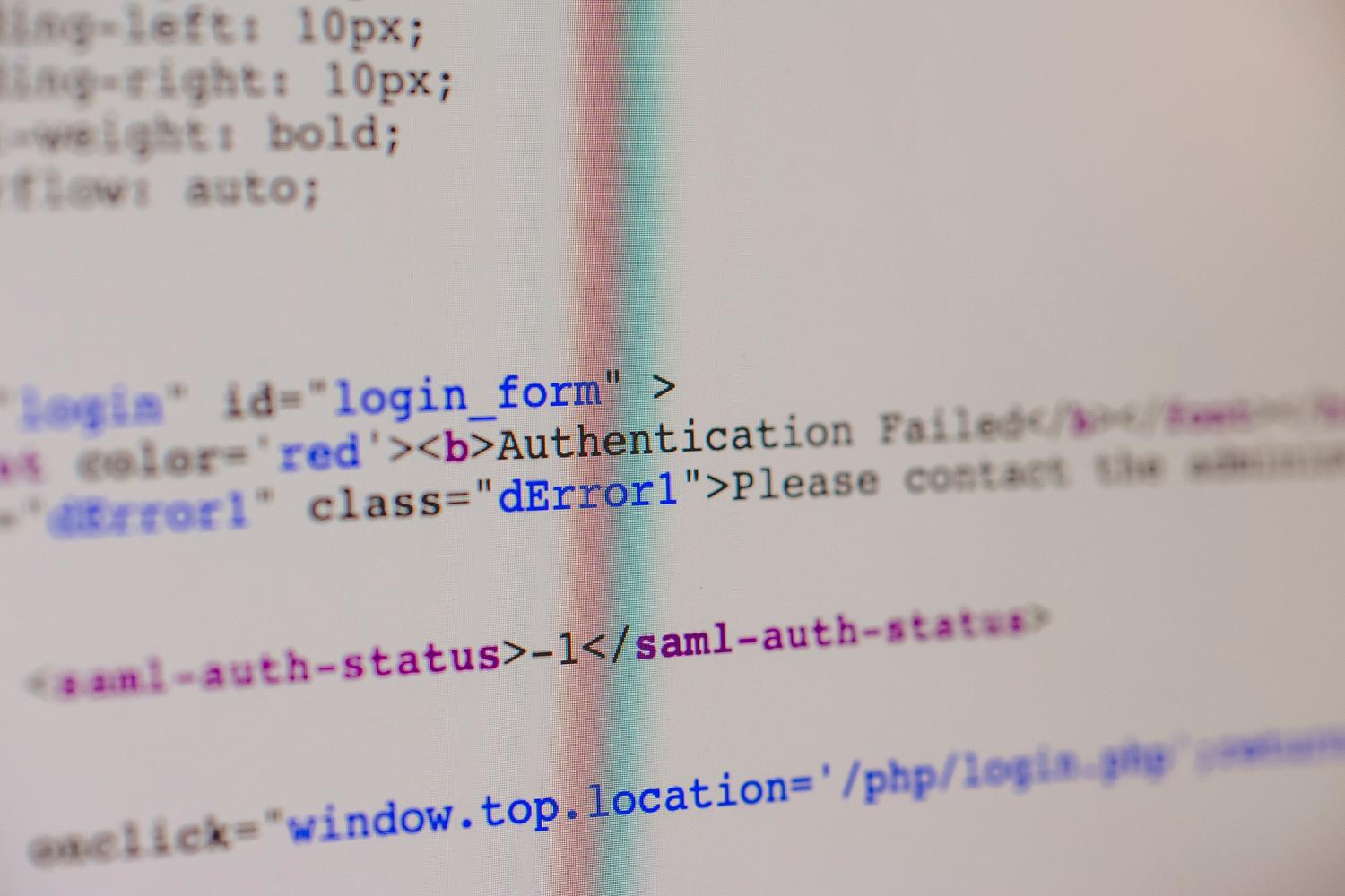Primer plano de un monitor con código PHP y un mensaje de fallo de autenticación, representando la detección de vulnerabilidades web.